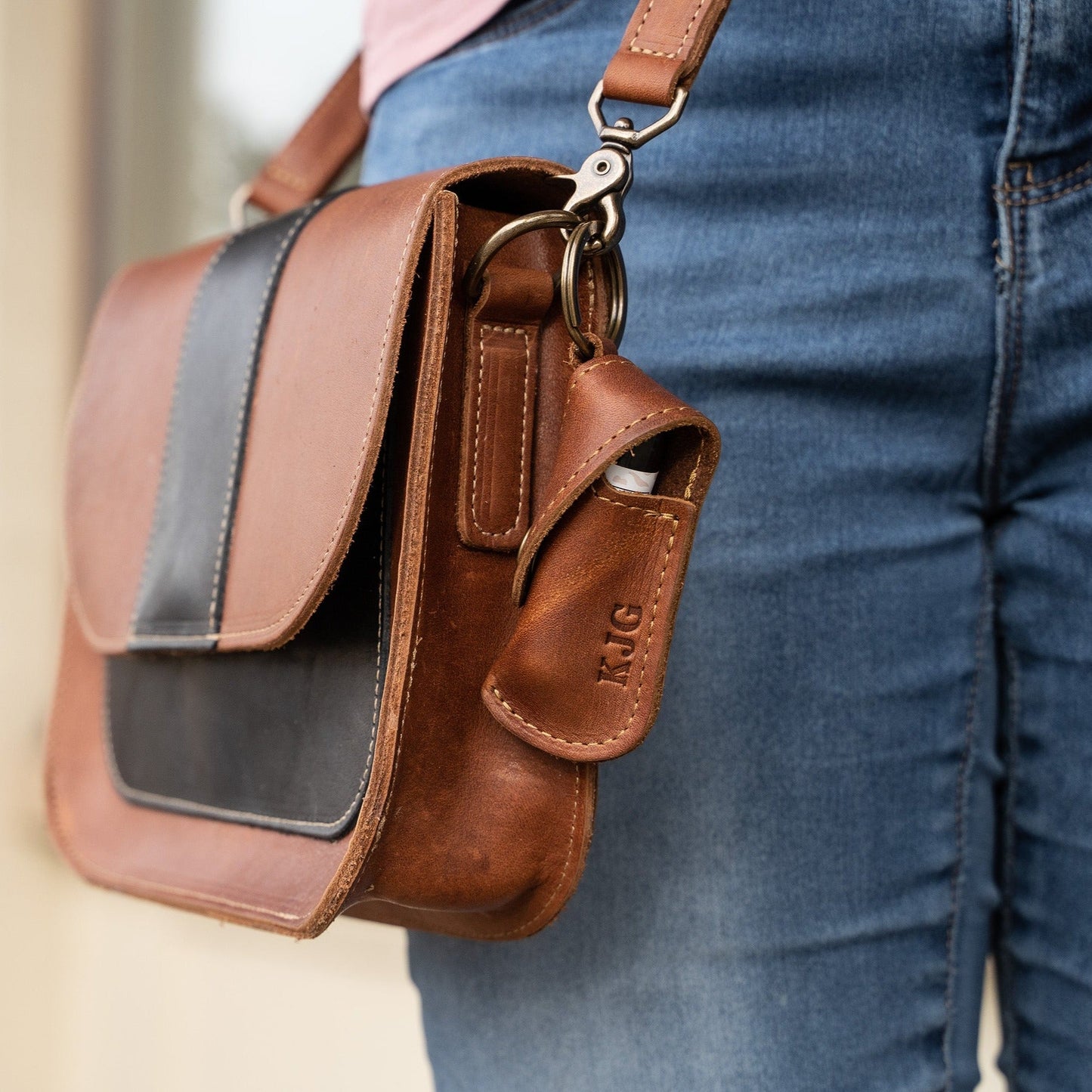 Keychain lip balm holder featuring button snap closure. Made with full-grain American leather. Customize with your initials. Makes for the perfect gift or stocking stuffer. Available in black or brown leather.
