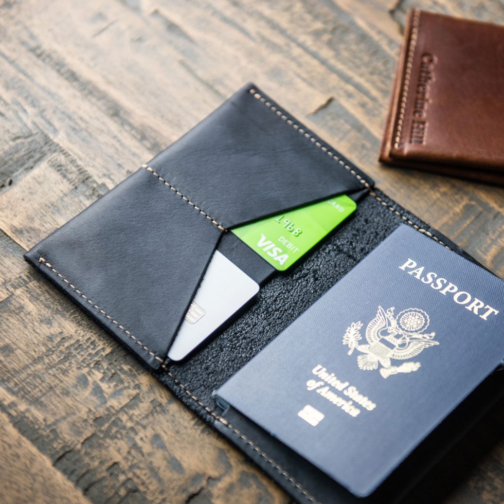 Black leather passport cover and wallet with two card pockets and two large pockets