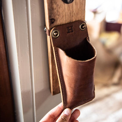 The Cooter Brown Personalized Whiskey Barrel Bottle Opener with detachable leather cap catch pouch