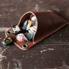 The Cooter Brown Personalized Whiskey Barrel Bottle Opener with detachable leather cap catch pouch